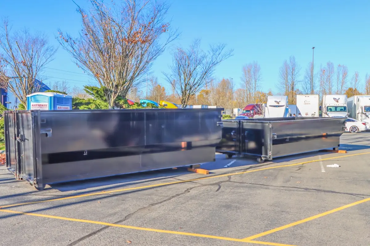 Professional dumpster rental service with roll-off container on residential driveway in Alexander City